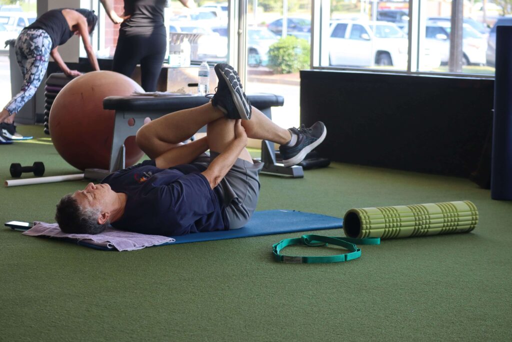 A Method Gym member doing a hip mobility exercise.