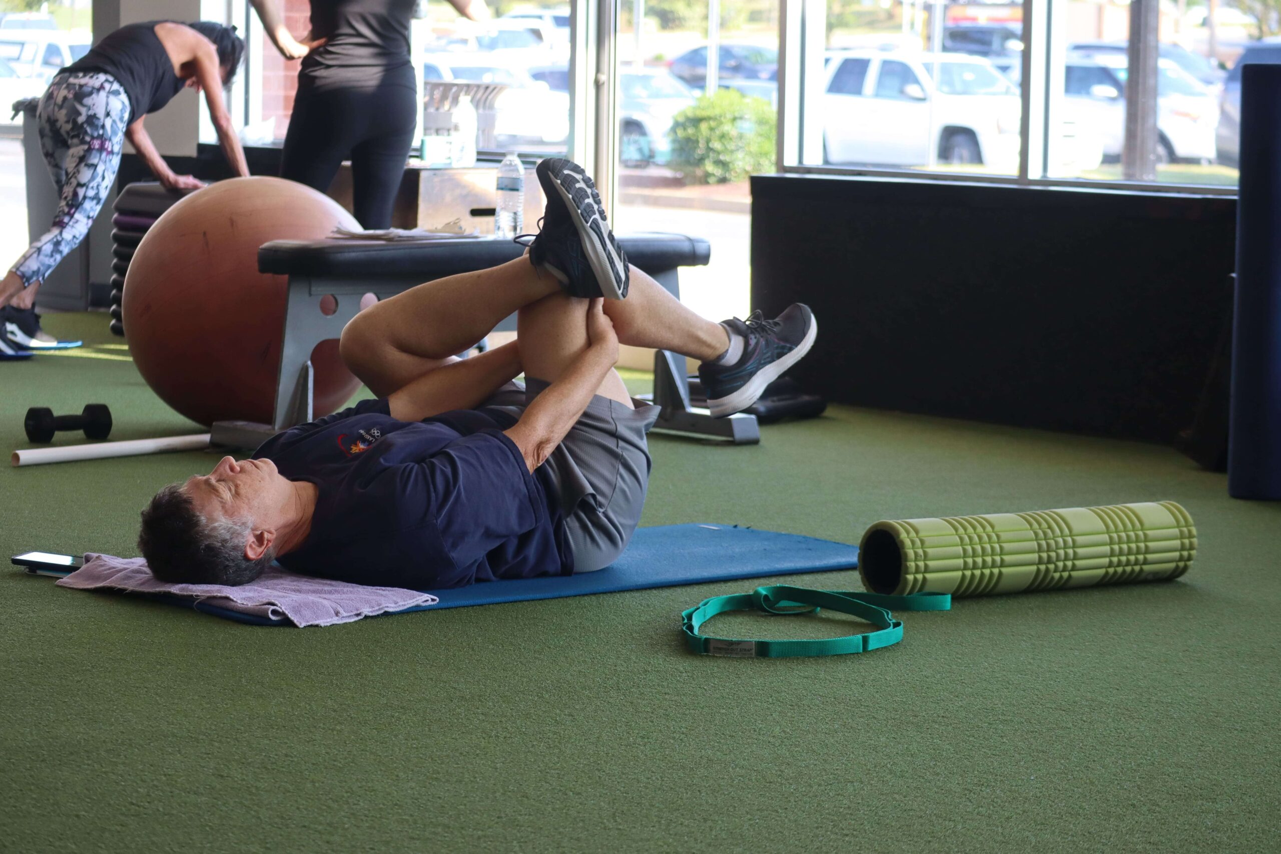 A Method Gym member doing a hip mobility exercise.