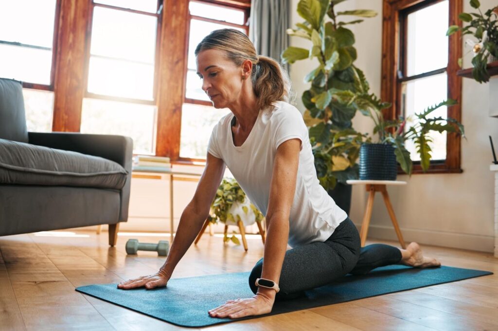 A woman doing a pigeon hip stretch.